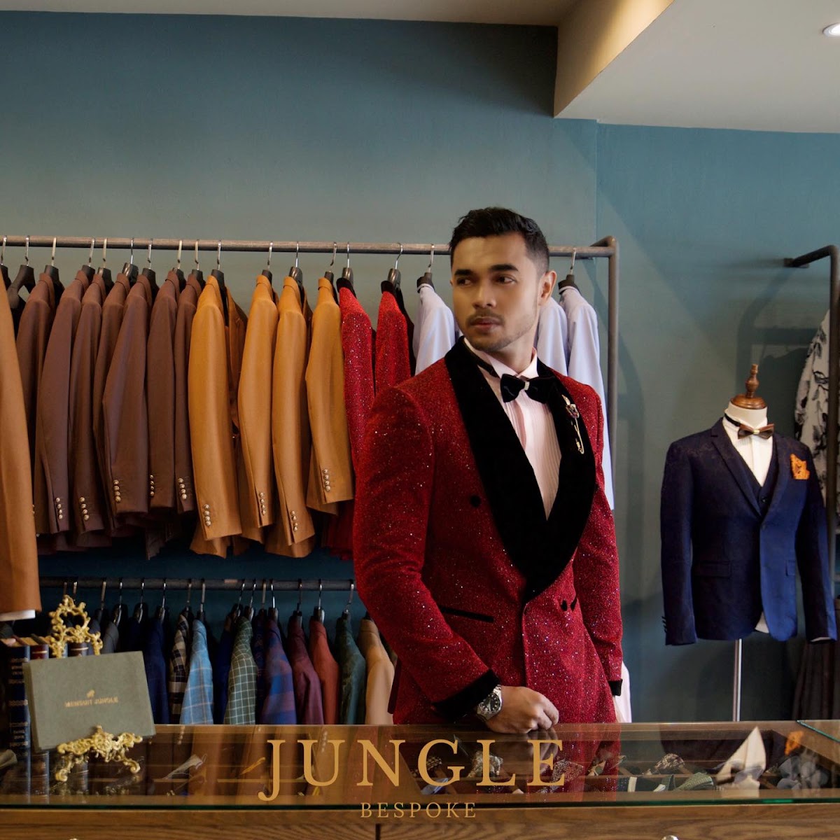 A customer wearing a custom red tuxedo at JUNGLE Bespoke